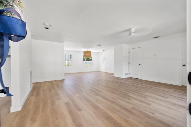 unfurnished living room with light hardwood / wood-style flooring and ceiling fan