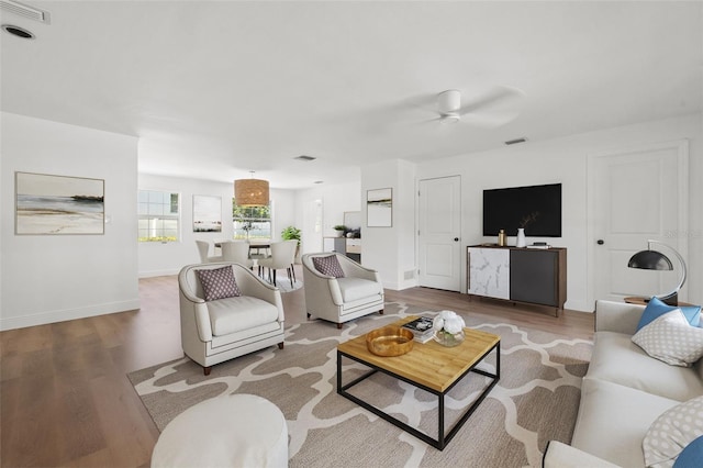 living room with hardwood / wood-style floors and ceiling fan