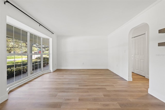 unfurnished room with light hardwood / wood-style floors and ornamental molding