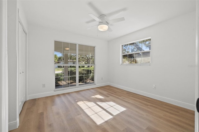 unfurnished bedroom with ceiling fan, a closet, and light wood-type flooring