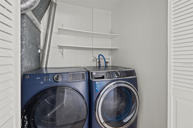 laundry room with washing machine and clothes dryer