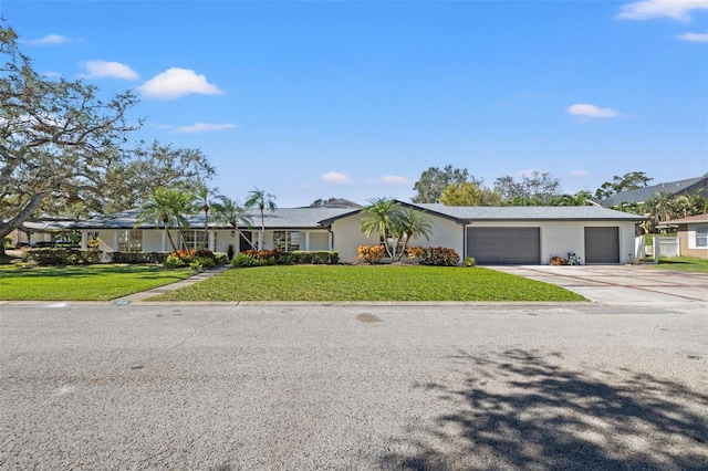 ranch-style home featuring a front lawn and a garage