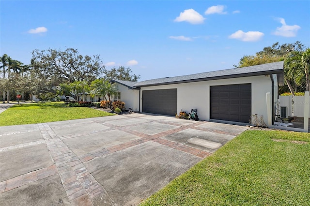 exterior space with a garage, central AC unit, and a lawn