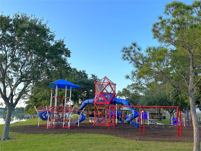 view of playground with a yard and a water view