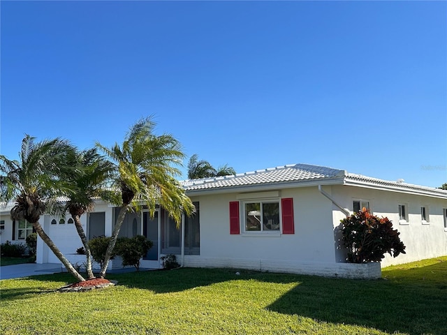 view of front of home with a garage and a front lawn