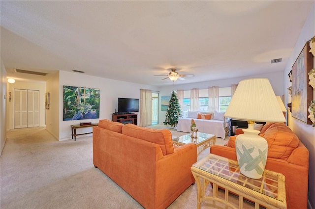 carpeted living room featuring ceiling fan