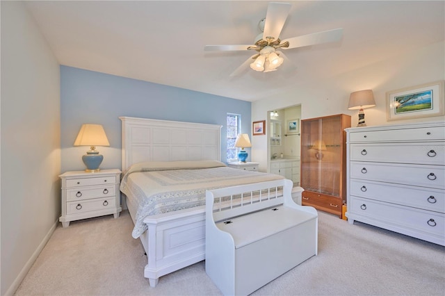 bedroom featuring ensuite bath, ceiling fan, and light colored carpet