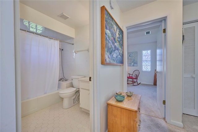 full bathroom featuring tile patterned flooring, vanity, toilet, and shower / bath combo with shower curtain