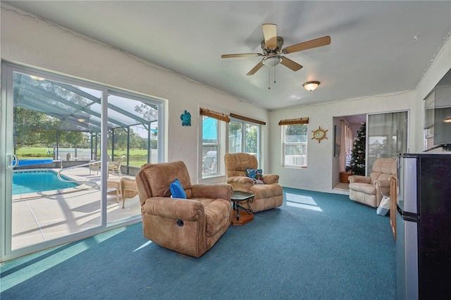 interior space with ceiling fan, carpet floors, and a swimming pool