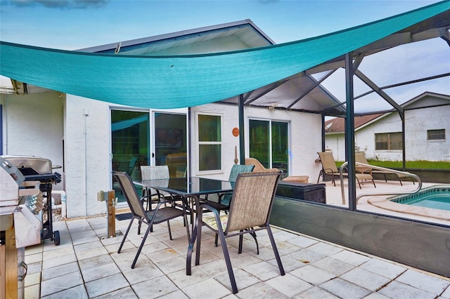 view of patio featuring a lanai and grilling area