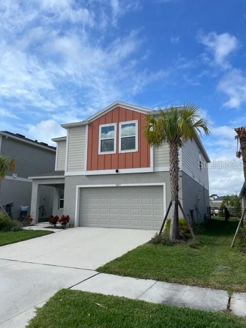 view of front facade with a front yard and a garage