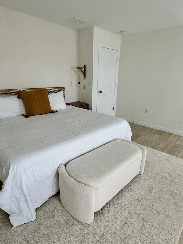 bedroom with hardwood / wood-style floors