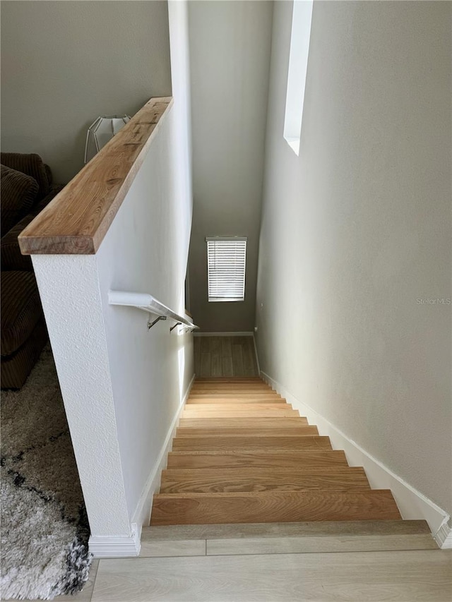 staircase featuring hardwood / wood-style floors