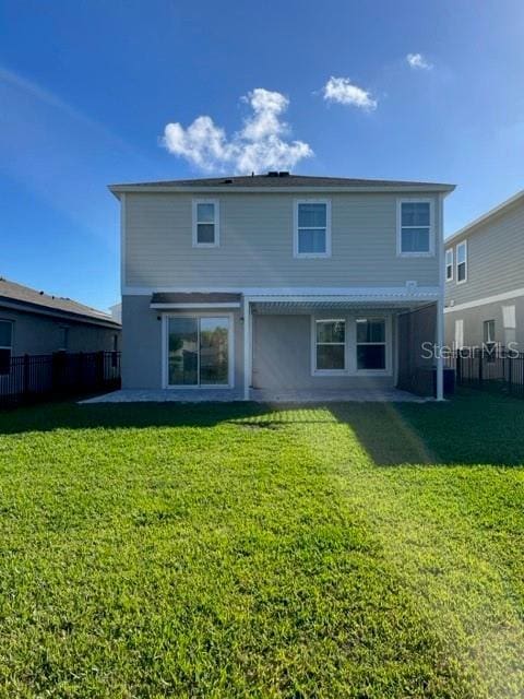 back of house with a lawn