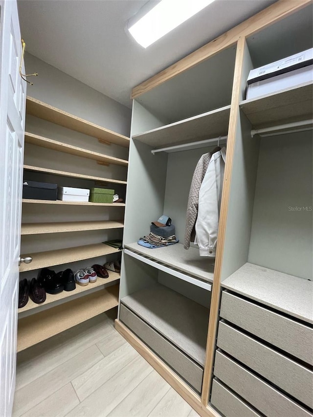 walk in closet featuring light hardwood / wood-style flooring