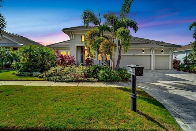 view of front of property featuring a yard and a garage