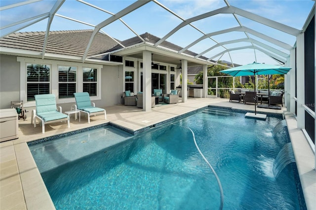 view of swimming pool with a lanai, an outdoor living space, pool water feature, and a patio