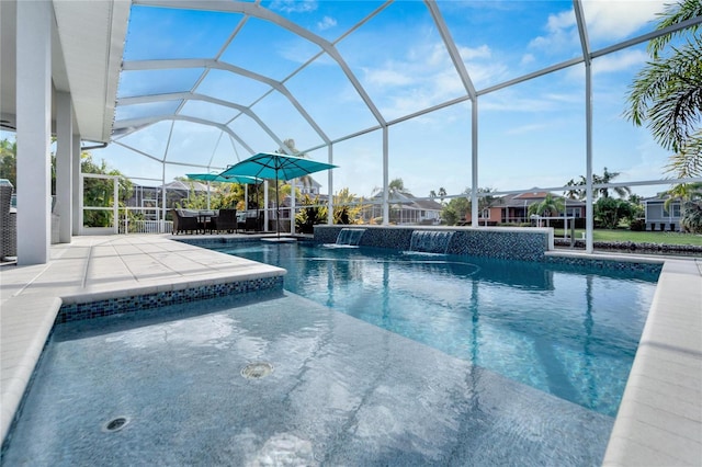 view of pool with a lanai, pool water feature, and a patio area