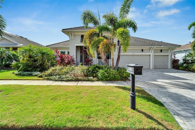 view of front of property with a garage and a front yard