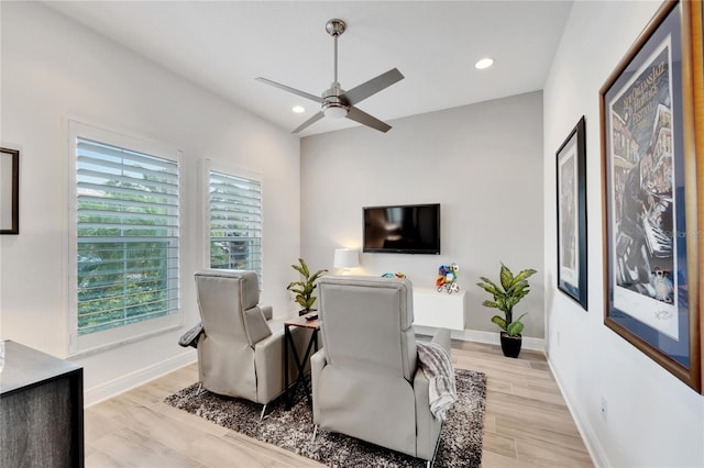 living area featuring ceiling fan and light hardwood / wood-style floors