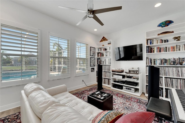 living room featuring ceiling fan and hardwood / wood-style floors