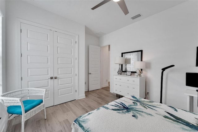 bedroom featuring light wood-type flooring, ceiling fan, and a closet