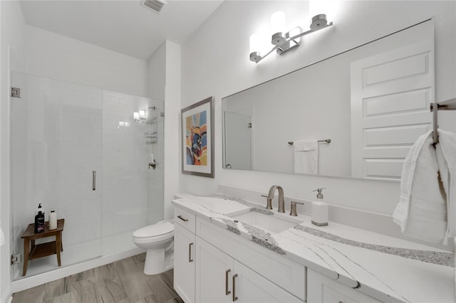 bathroom with a shower with shower door, hardwood / wood-style floors, toilet, and vanity