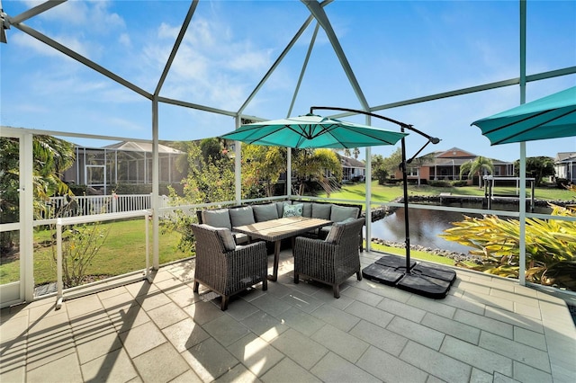 sunroom / solarium featuring a water view