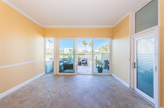 tiled spare room featuring plenty of natural light and crown molding