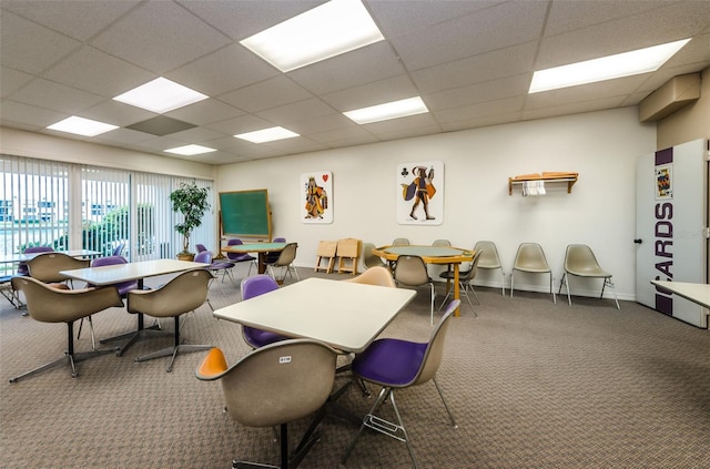 interior space with a drop ceiling and carpet floors