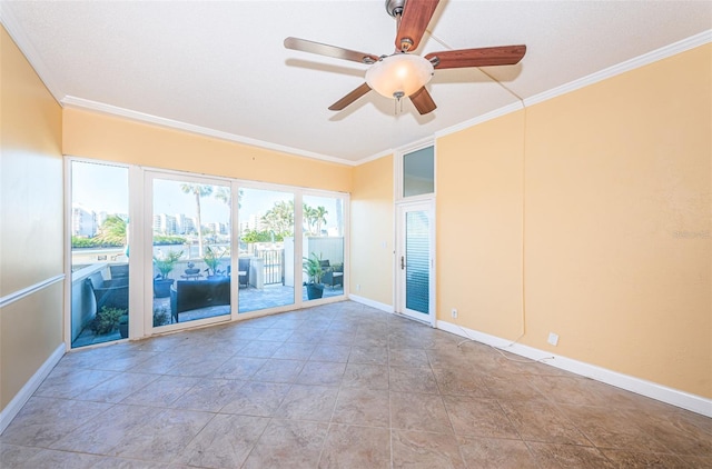 unfurnished room featuring baseboards, ornamental molding, and ceiling fan