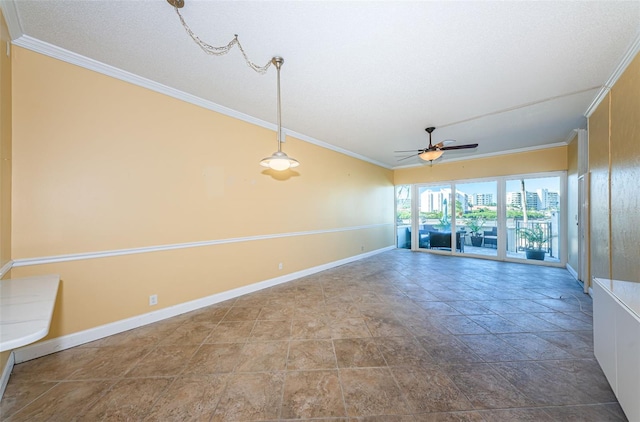 unfurnished room featuring baseboards, ornamental molding, a ceiling fan, and a view of city