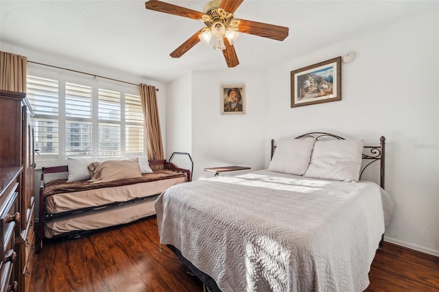 bedroom with ceiling fan and dark hardwood / wood-style floors