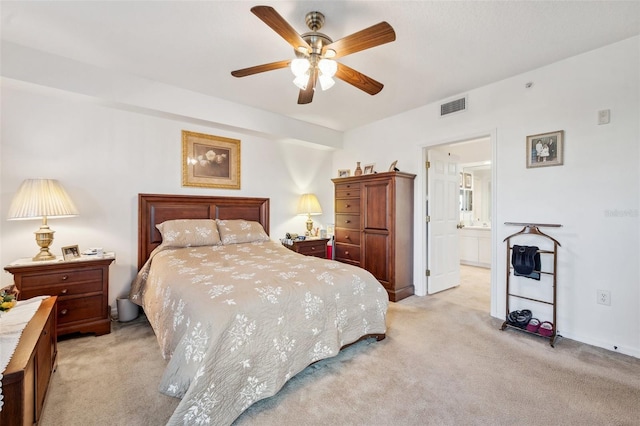 carpeted bedroom with connected bathroom and ceiling fan