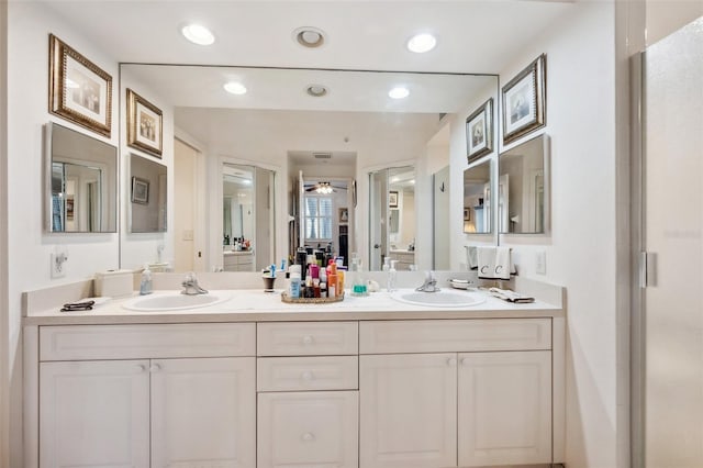 bathroom with walk in shower, vanity, and ceiling fan