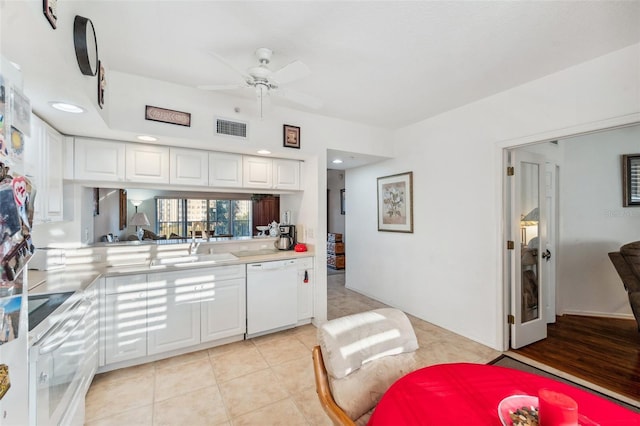 kitchen with ceiling fan, dishwasher, sink, light tile patterned floors, and white cabinets