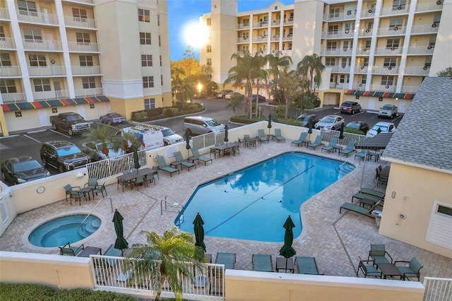 view of pool with a community hot tub and a patio