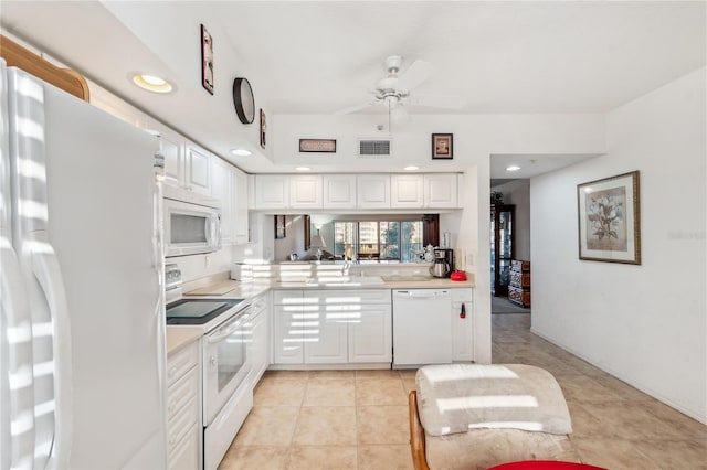 kitchen with white appliances, ceiling fan, sink, light tile patterned floors, and white cabinetry