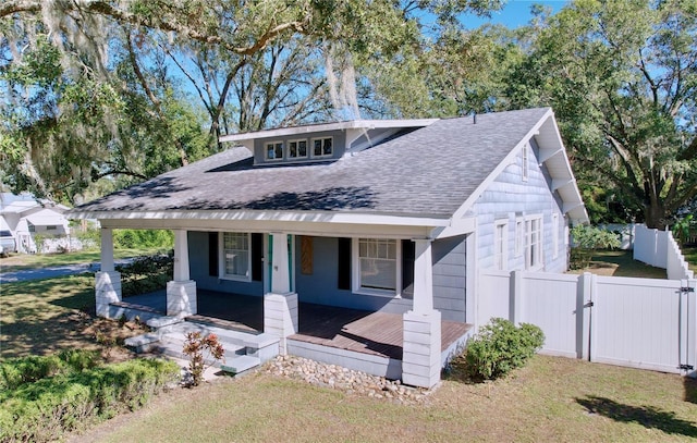 view of front of property with a porch and a front yard