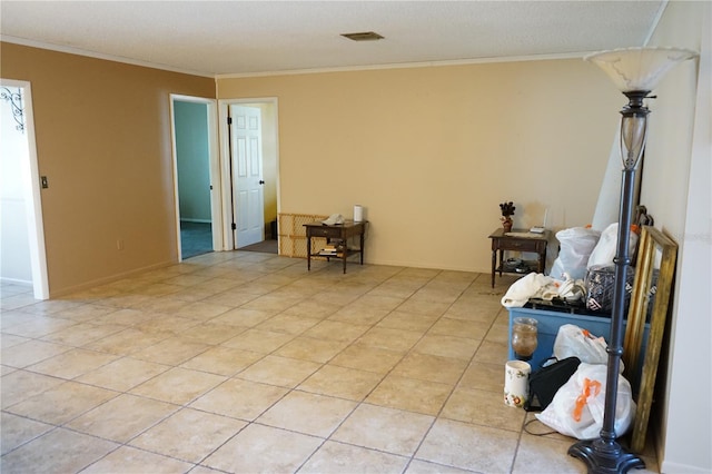 living area with light tile patterned floors and ornamental molding