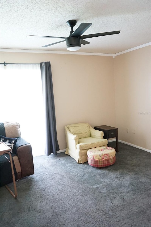 living area with crown molding, dark carpet, and a textured ceiling