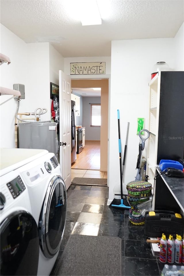 clothes washing area with separate washer and dryer, dark hardwood / wood-style floors, and a textured ceiling