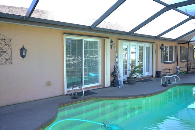 view of swimming pool with a patio area and a lanai