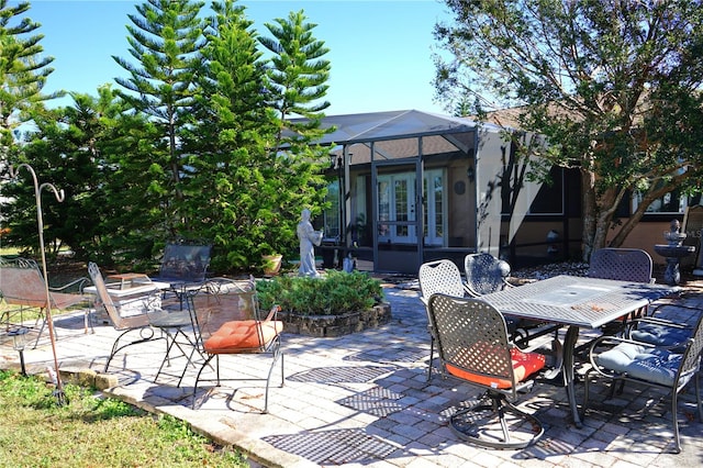 view of patio / terrace featuring glass enclosure