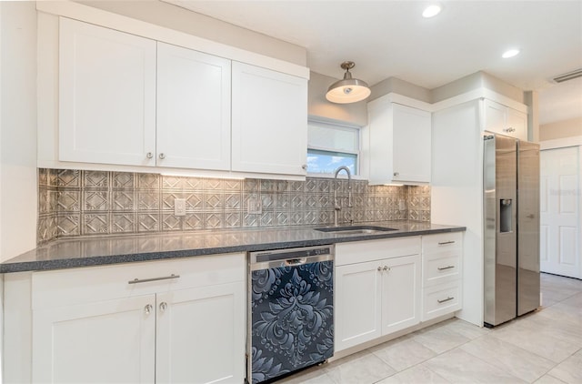 kitchen with appliances with stainless steel finishes, tasteful backsplash, white cabinetry, and sink