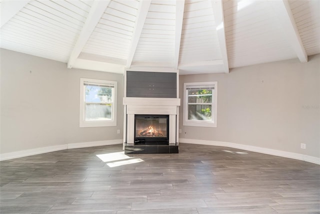 unfurnished living room featuring hardwood / wood-style flooring, vaulted ceiling with beams, wood ceiling, and a fireplace