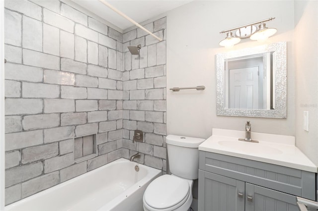 full bathroom with vanity, tiled shower / bath, and toilet