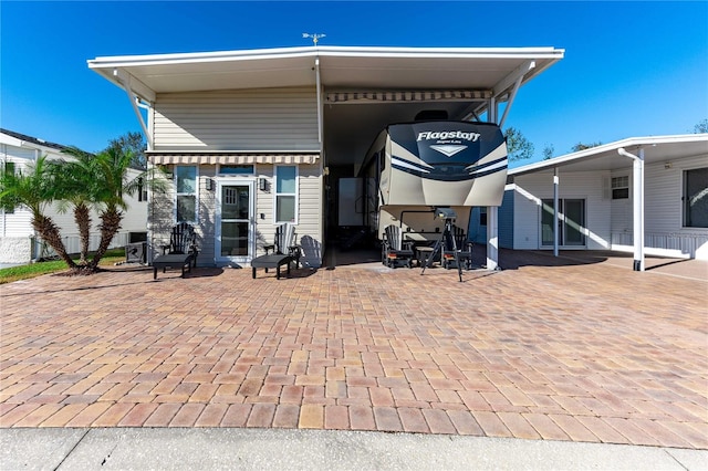 rear view of property featuring a carport