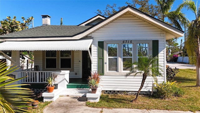 bungalow-style home featuring a porch and a front yard