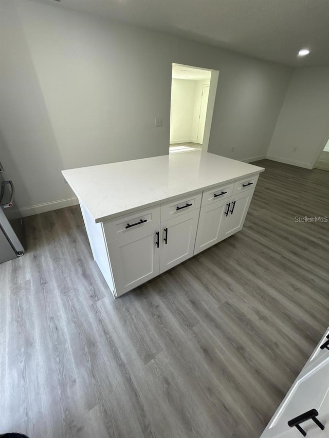 kitchen featuring a center island, light hardwood / wood-style flooring, and white cabinets